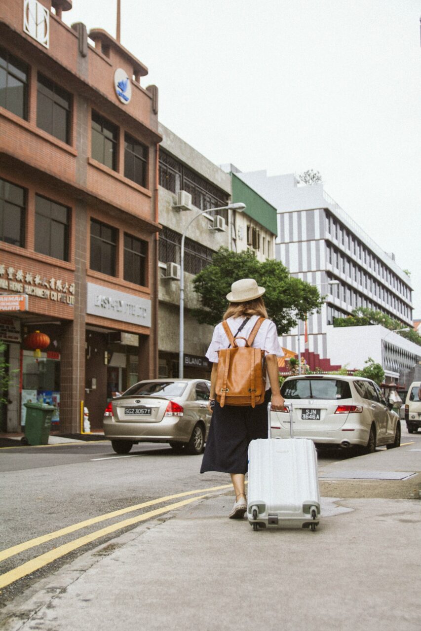 Woman in the street pulling a suitcase