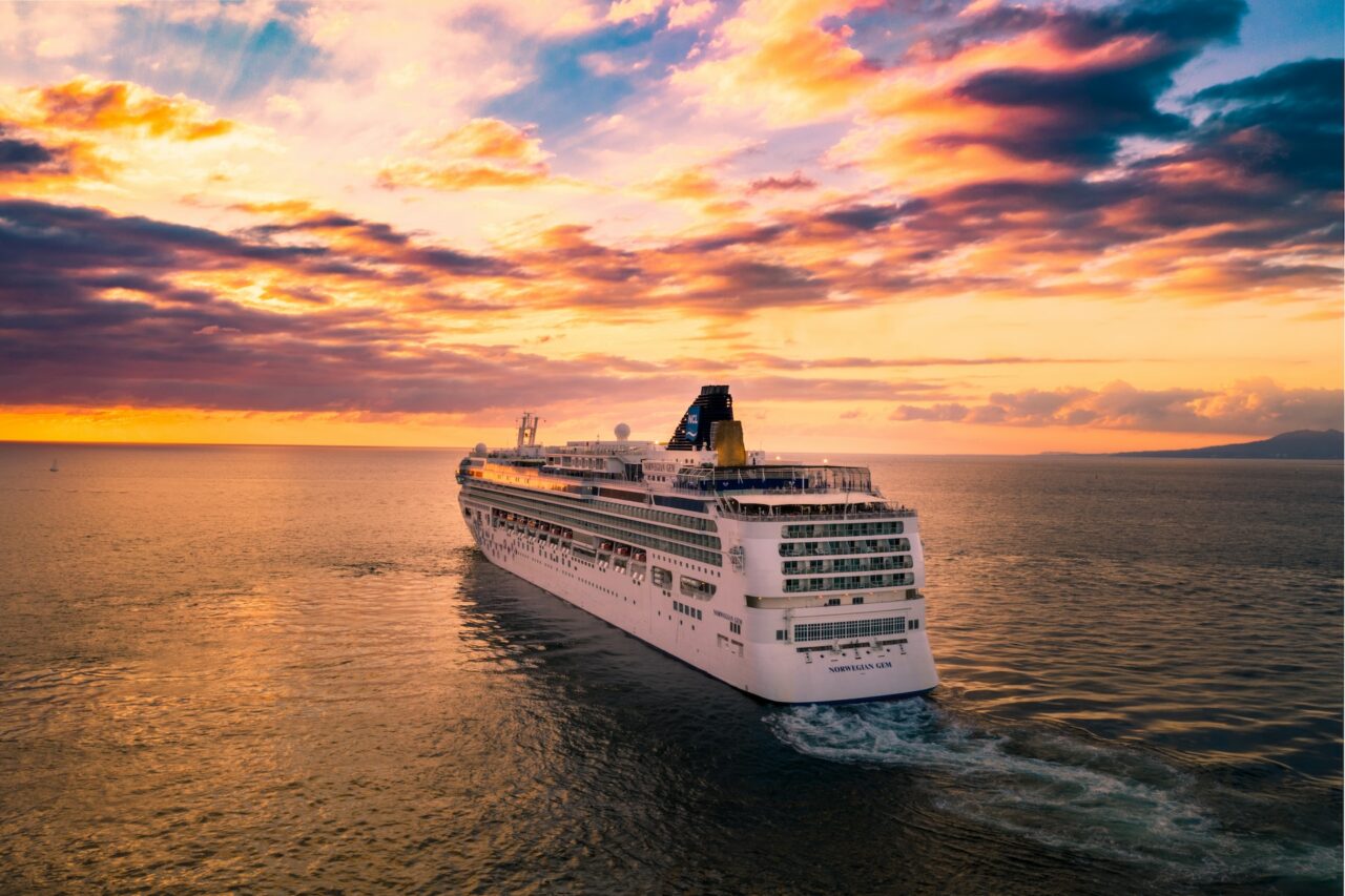 Cruise ship on the ocean at sunset