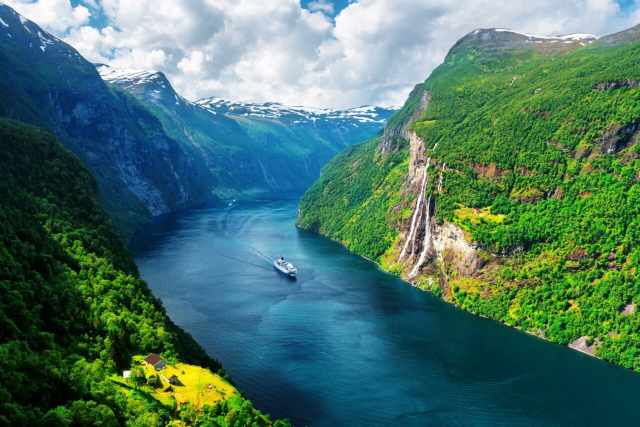 Cruise ship sailing through a fjord