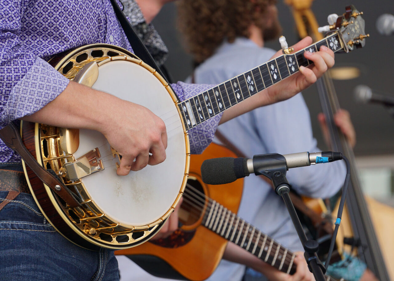 Man playing the banjo in a bluegrass band