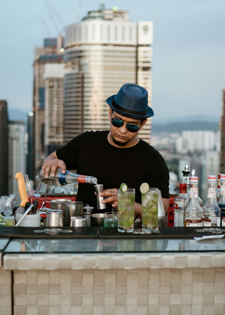 Bartender preparing cocktails at a rooftop bar in Kuala Lumpur