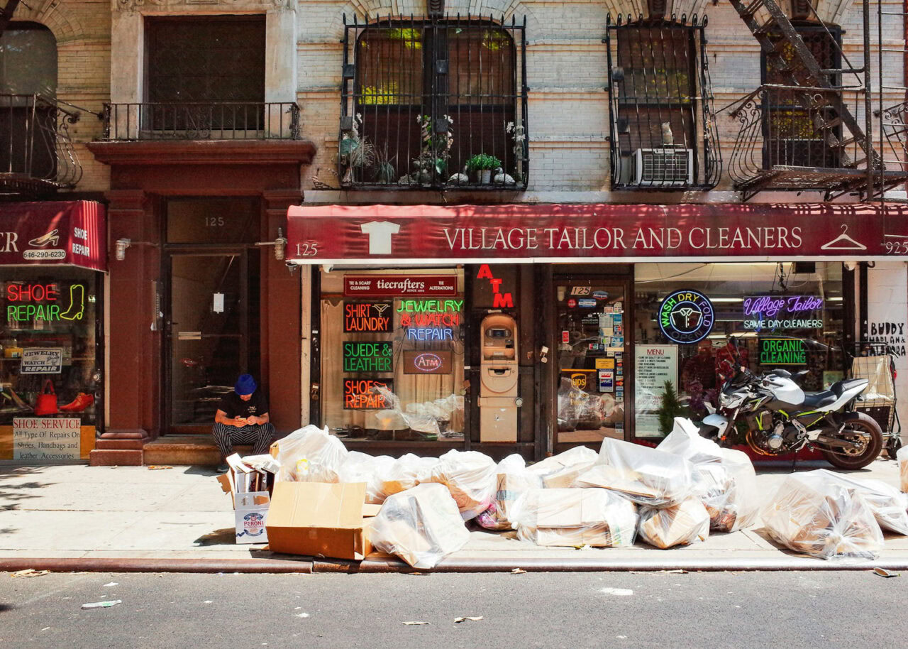 Garbage on the street in front of a tailor shop
