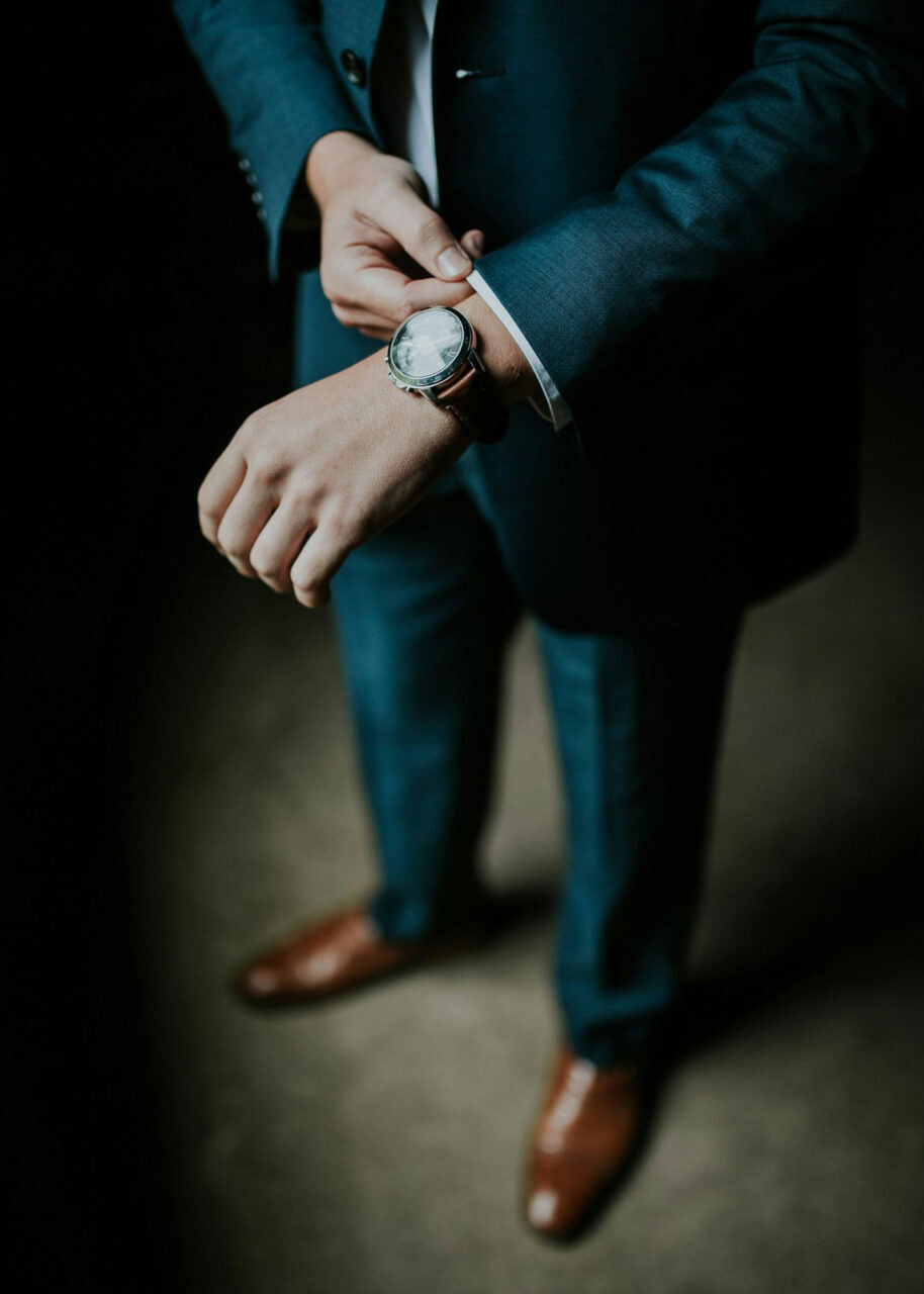 Close up of man in blue suit with watch
