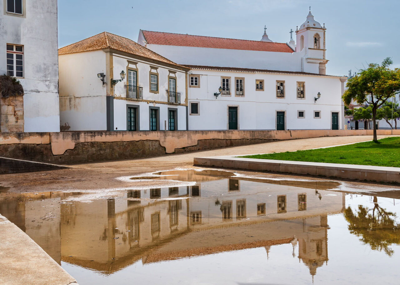 Church of San Antonio in the city of Lagos, Portugal, side view and reflected in the water.