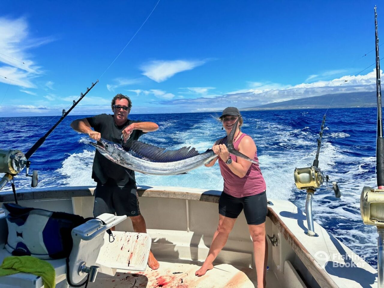Two people holding a fish on a boat in Costa Rica