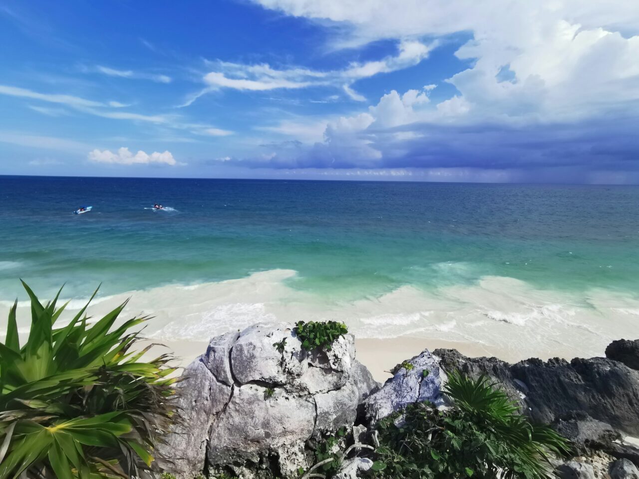 White sandy beach and blue ocean in Tulum, Mexico