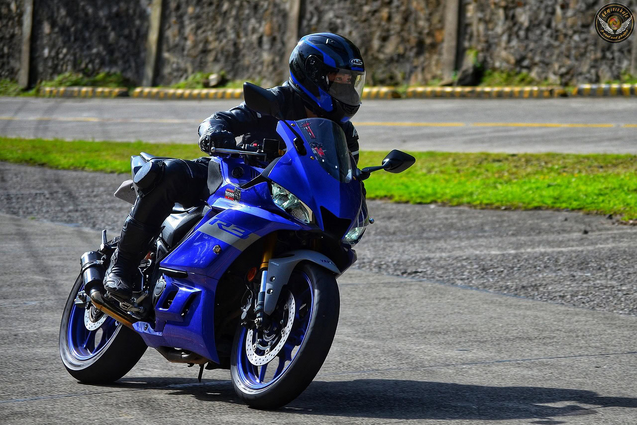 Person riding a blue motorbike