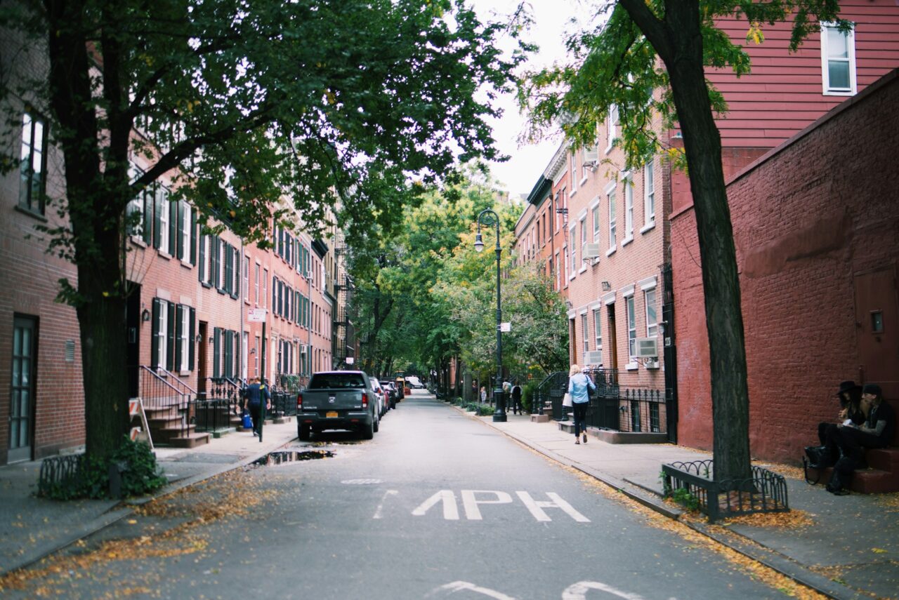 Leafy street with red brick buildings in West Village, Manhattan